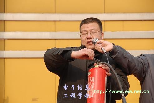 政教處副主任席明閏演示滅火器的使用方法